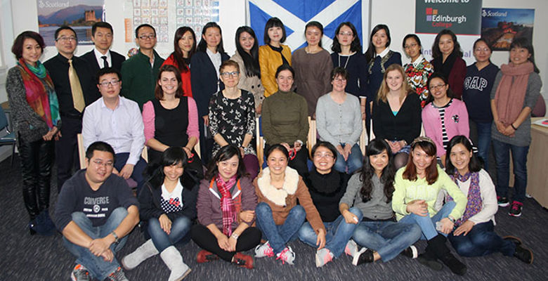 Group of exchange students and representatives from China posing for a group photo.