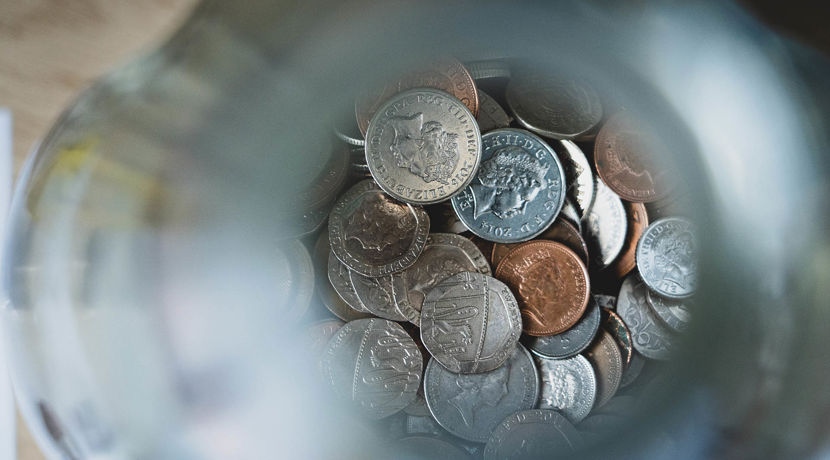 Pot of money with coins at the bottom.