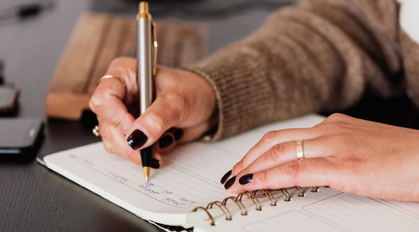 Close up of someone writing in their diary.